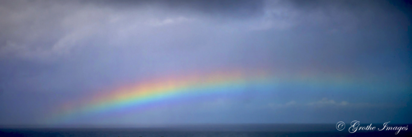 Rainbow over Pacific Ocean, observed from Kilauea Point Lighthouse, Kauai, Hawaii