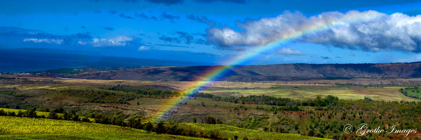 Rainbow observed from open door helicopter above Kauai, Hawaii