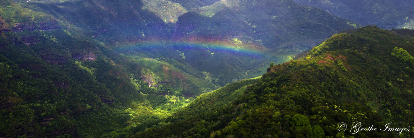 Rainbow observed from open door helicopter above Kauai, Hawaii