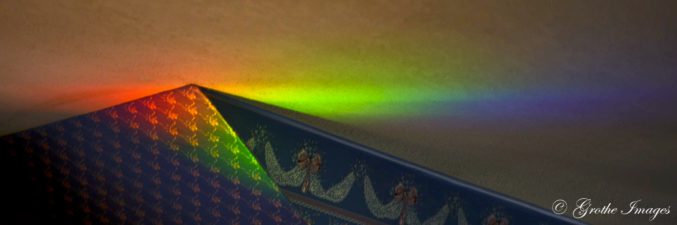 Refracted light creating a light spectrum on a ceiling